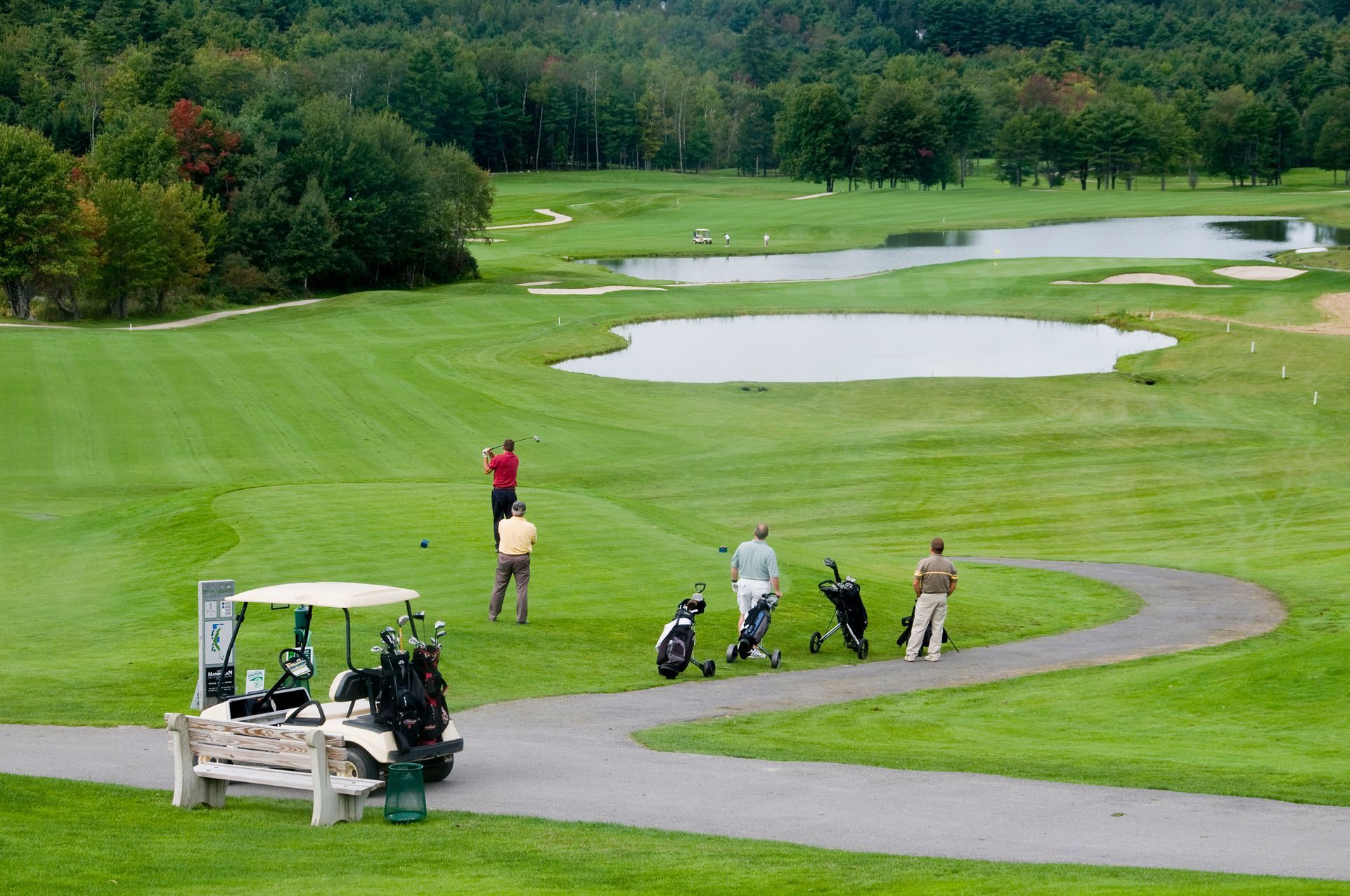 A group of people are playing golf on a golf course