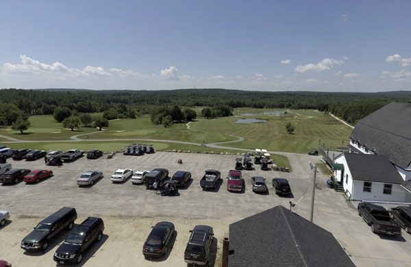 An aerial view of a parking lot with lots of cars parked