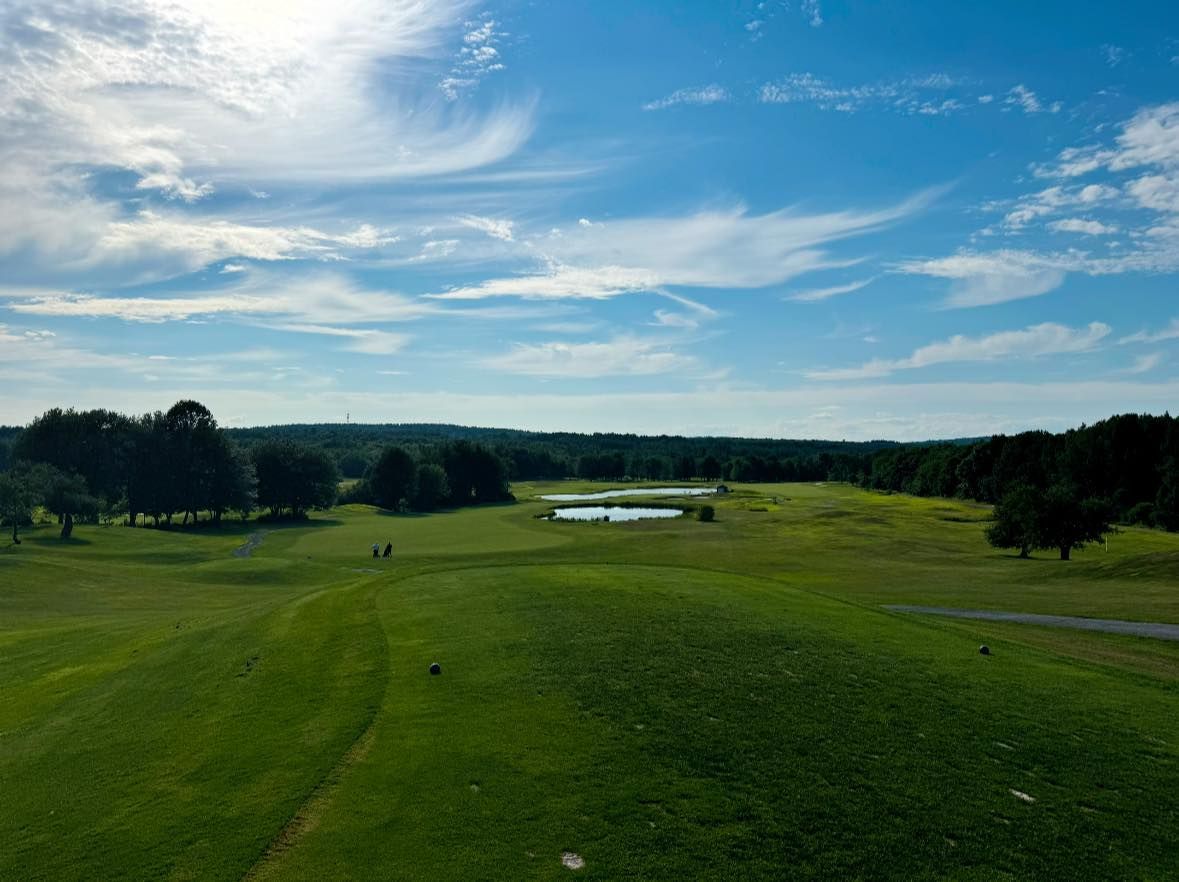 An aerial view of a golf course on a sunny day.