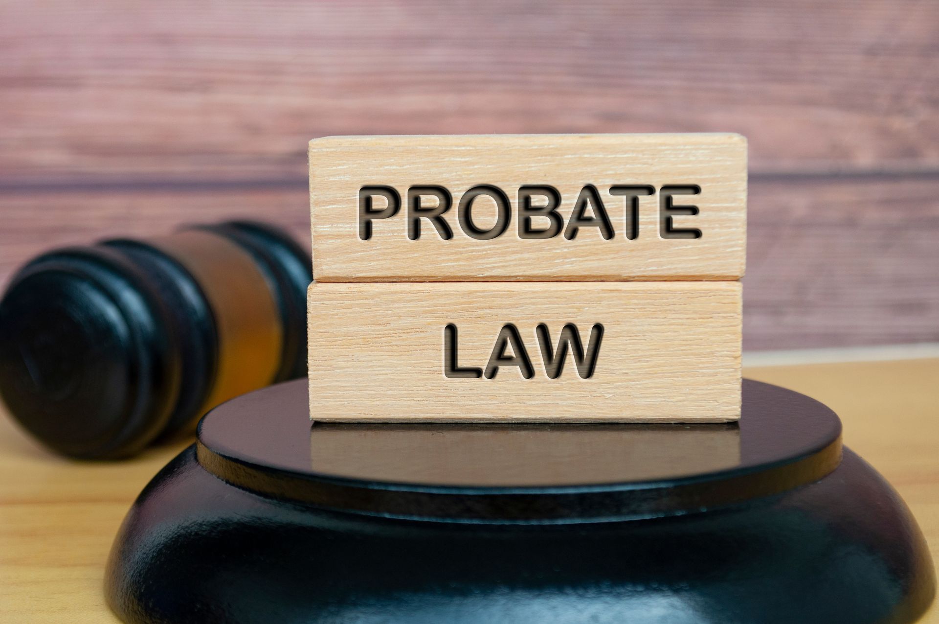 Probate law engraved on wood with gavel background.