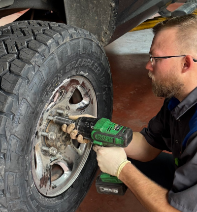 Our Mechanic Works on a Tire in Spartanburg, SC - Advantage AC, Tire & Repair