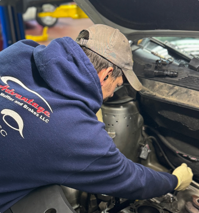 Our Technician is Working on a Vehicle - Advantage AC, Tire & Repair