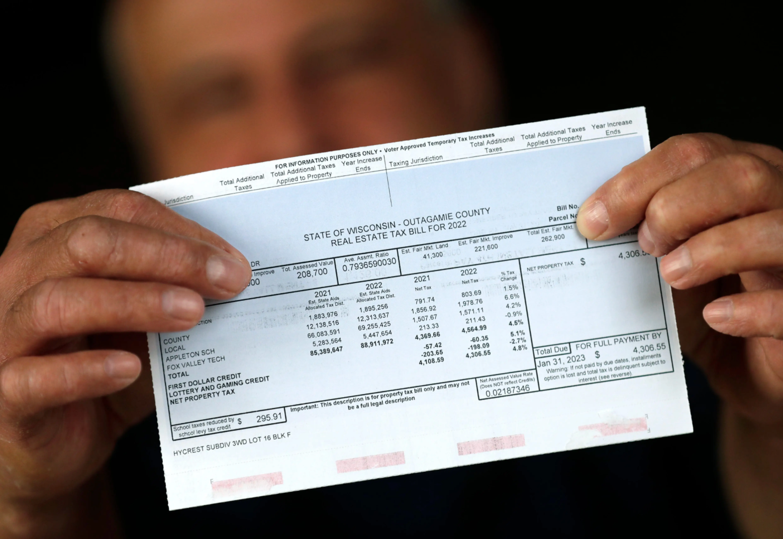 A man is holding a receipt in his hands