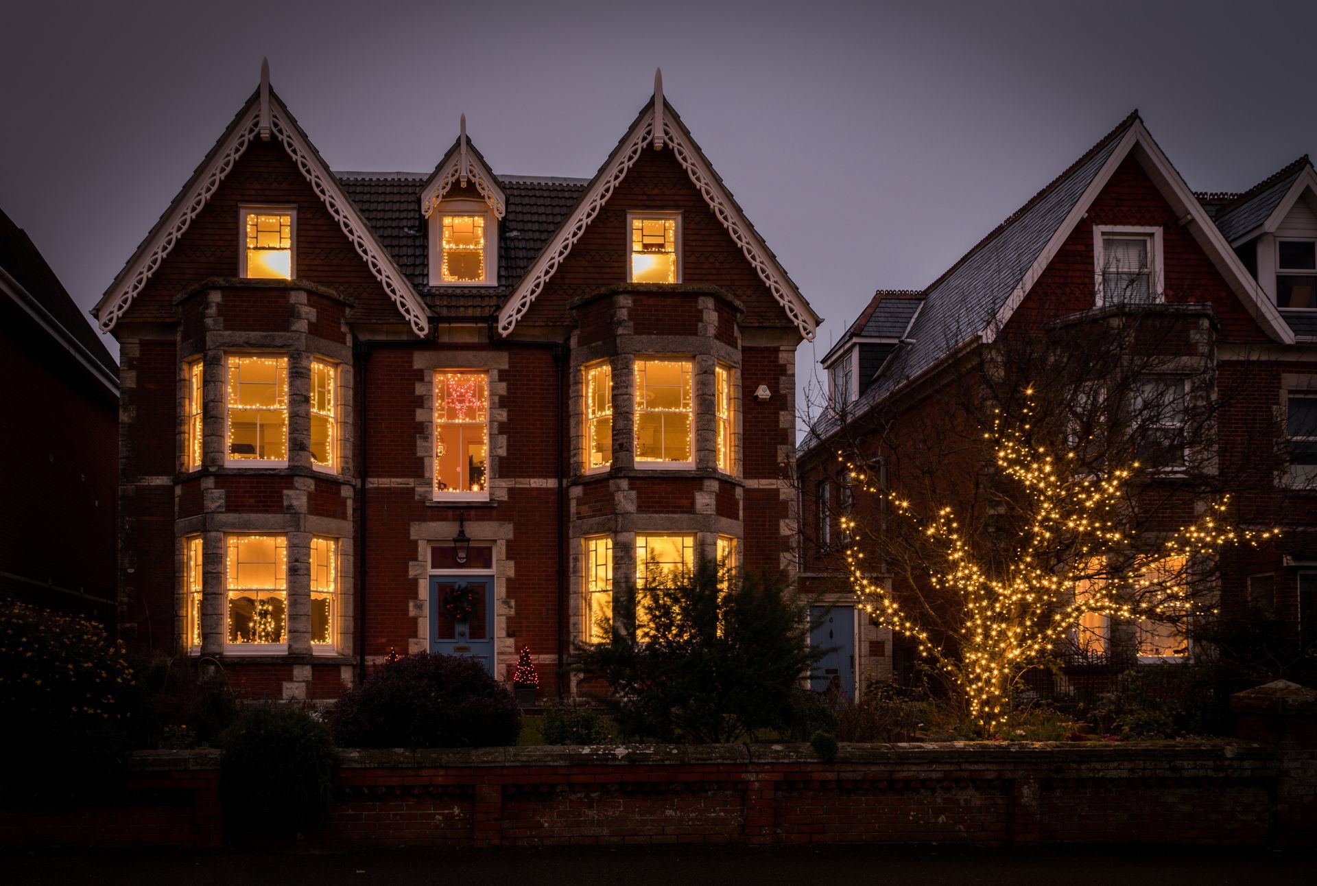 Modern apartment buildings with illuminated windows at dusk.