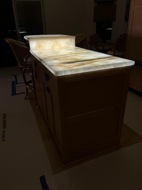 A kitchen island with a glow in the dark counter top.