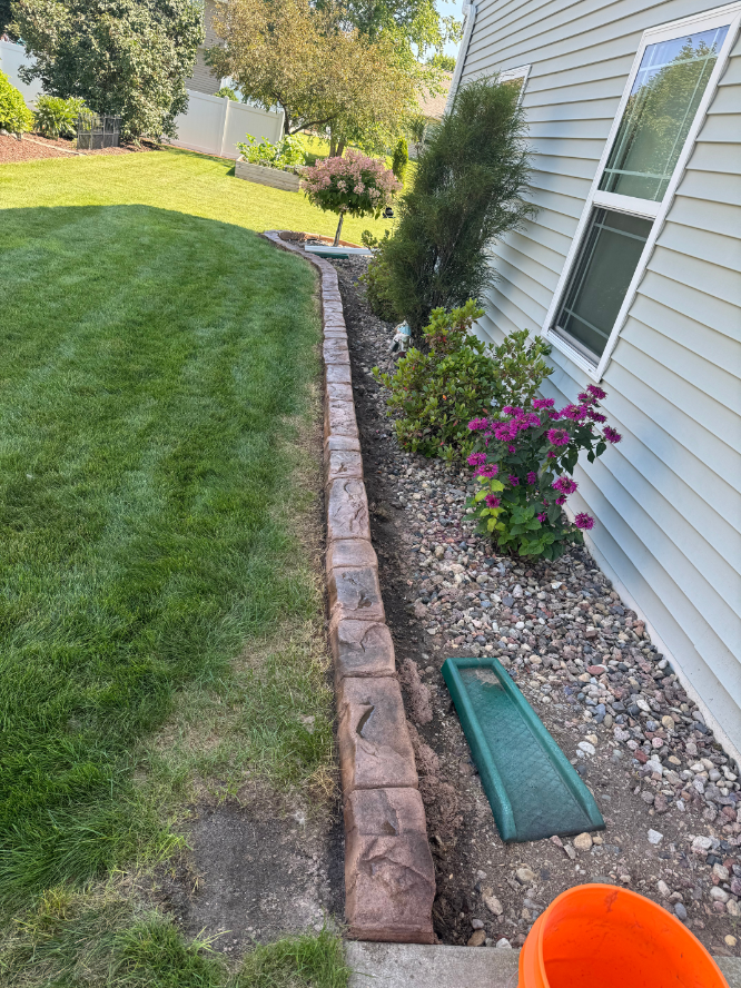 A sidewalk is being built in front of a house.