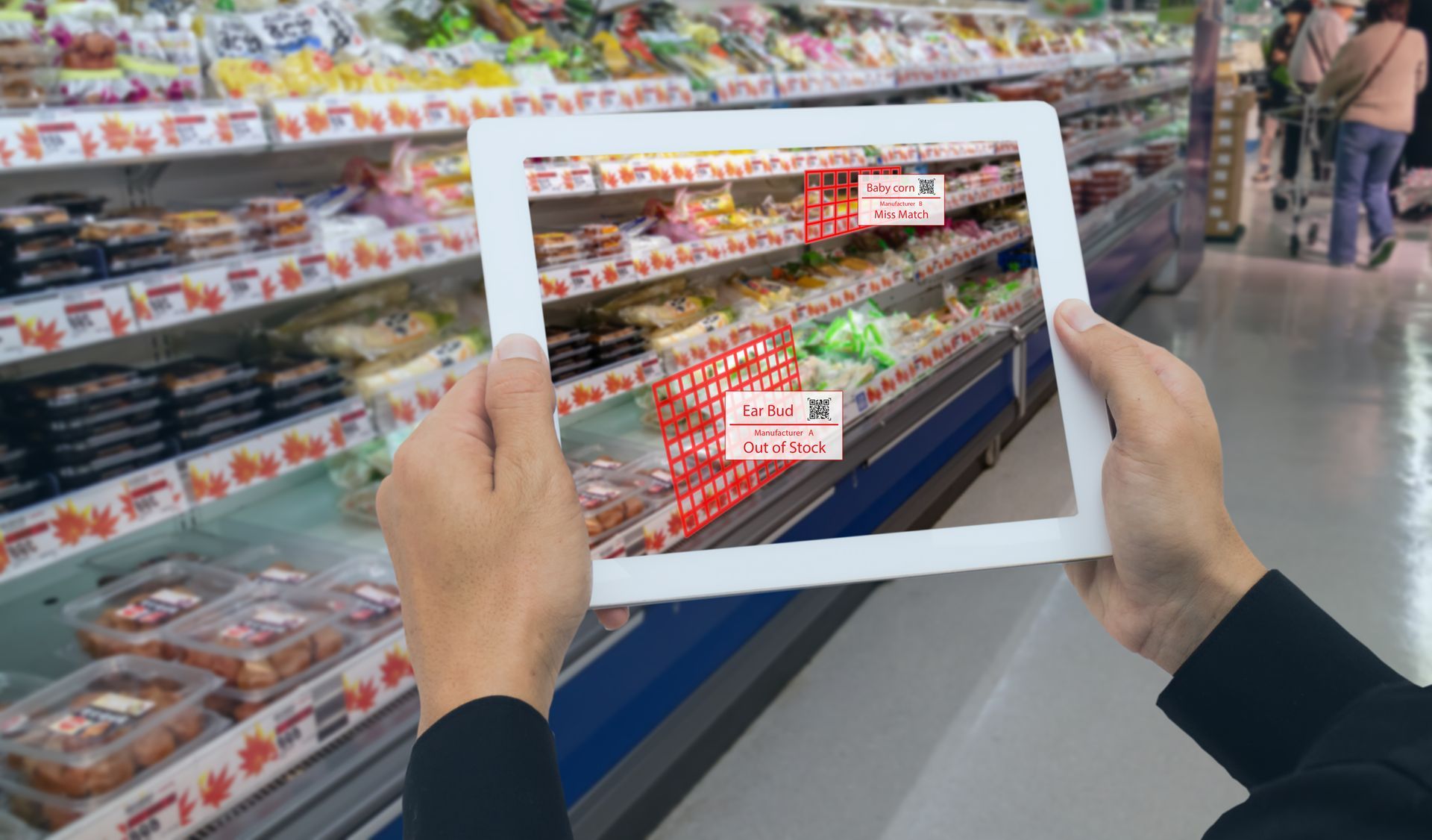 A man holds a tablet up to a supermarket aisle and listens as it reads out the items for sale.