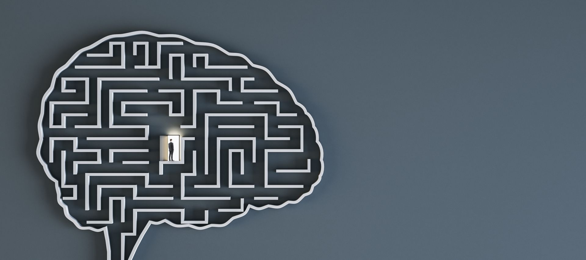 A figure stands in an open door positioned in the middle of a maze shaped like the human brain.