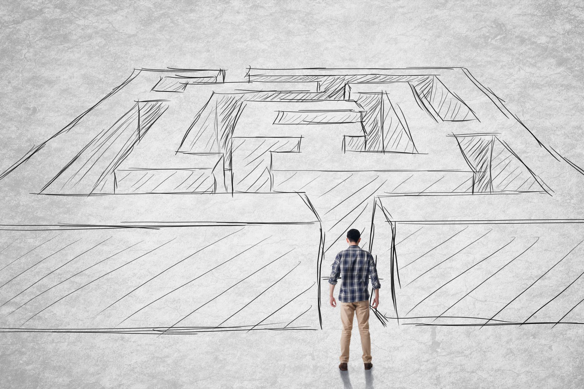 A man prepares to enter a penned drawing of a maze.