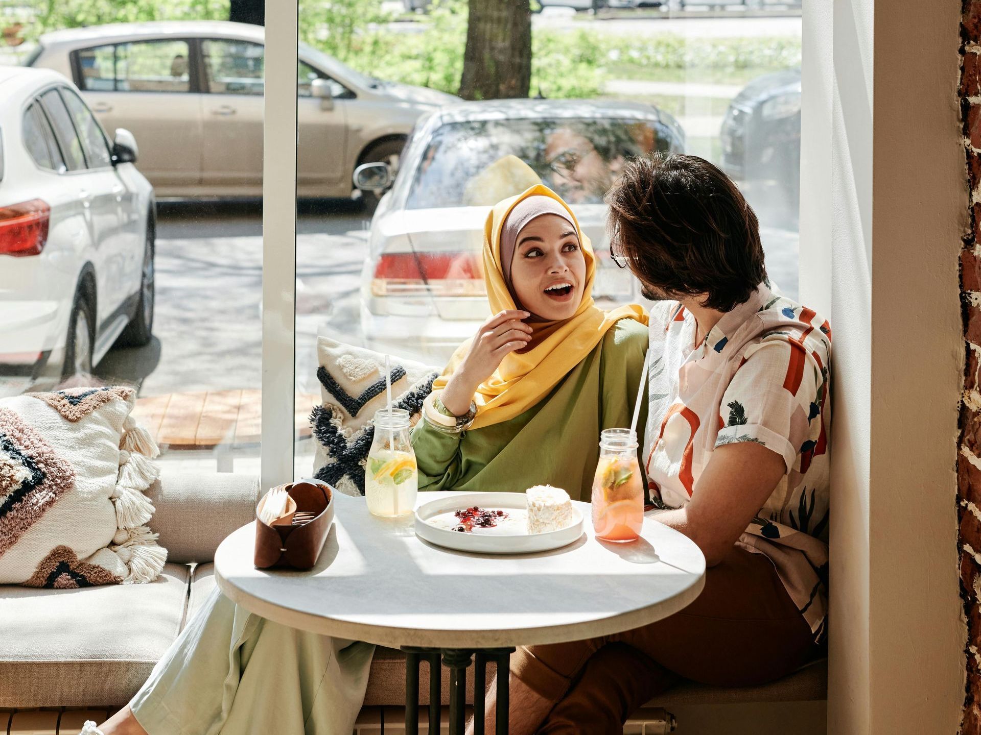 two people holding hands across a table in a quiet café, sharing warmth and unspoken understanding