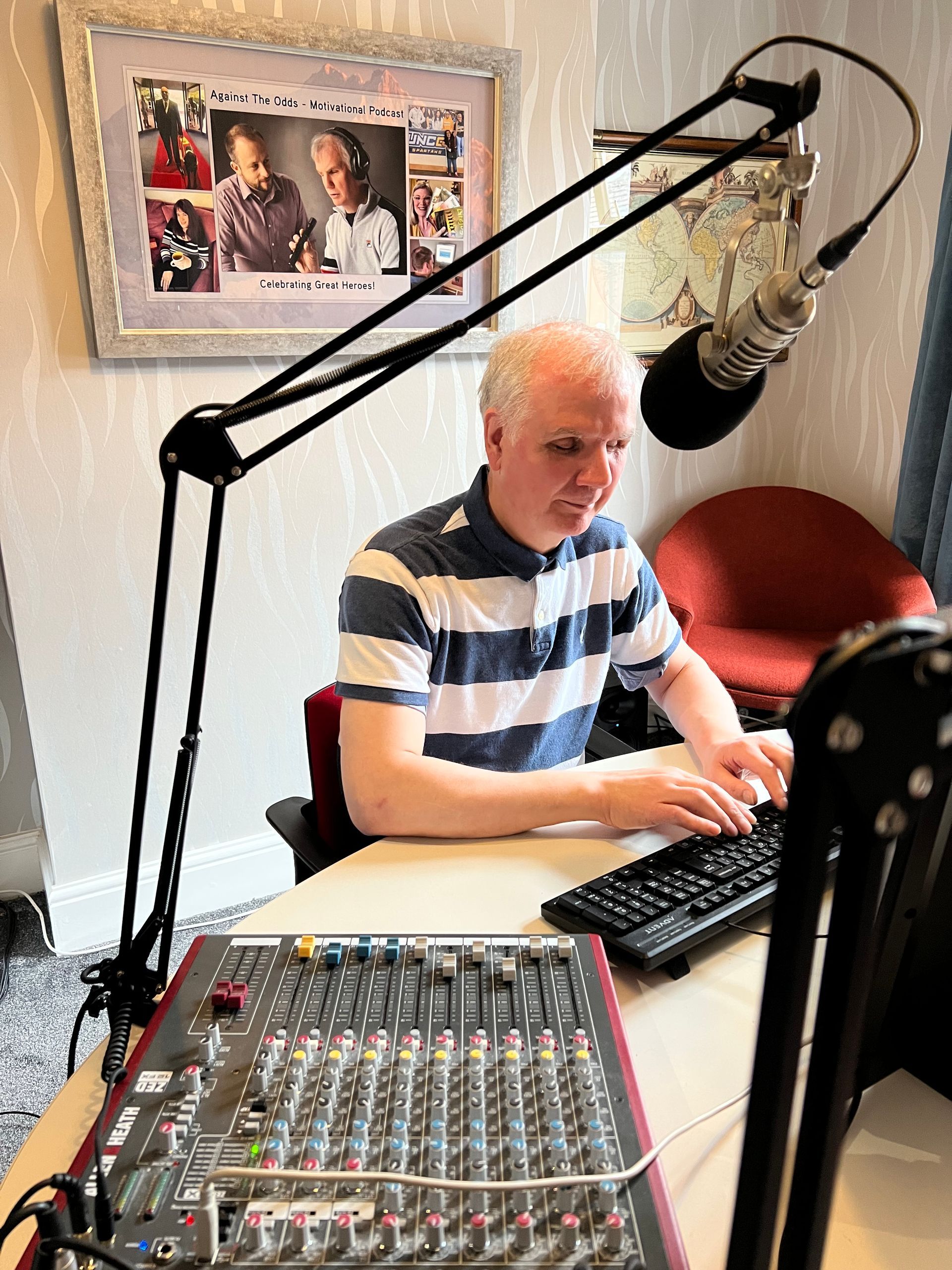 A microphone hovers over the desk and other recording equipment.