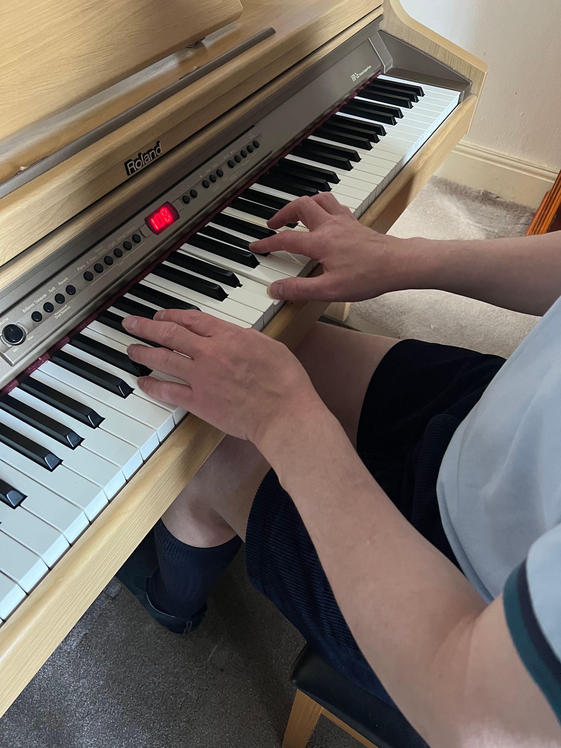 A close-up of Philip Anderson's hands as he plays the piano.