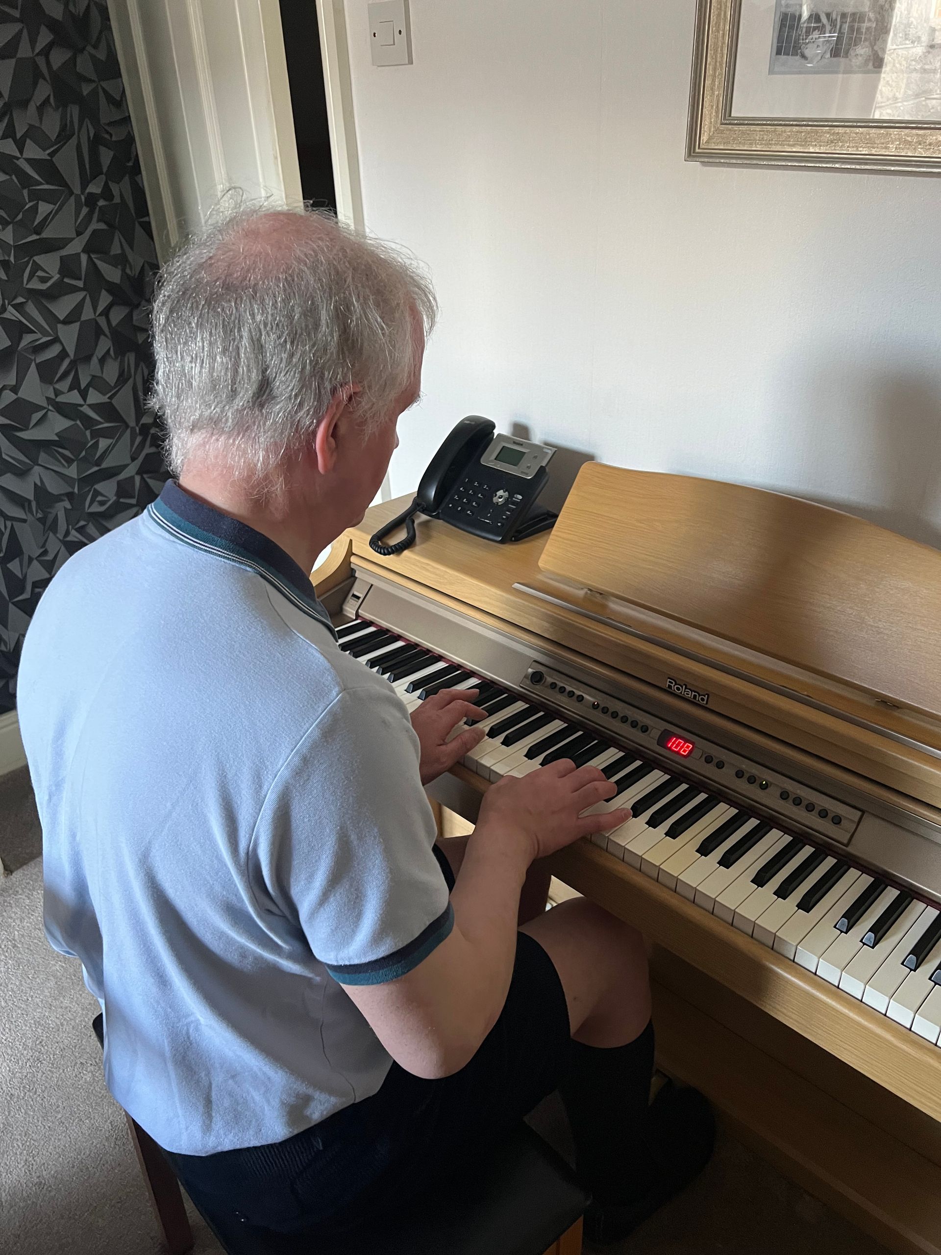 Philip Anderson playing piano, focusing on his right hand.
