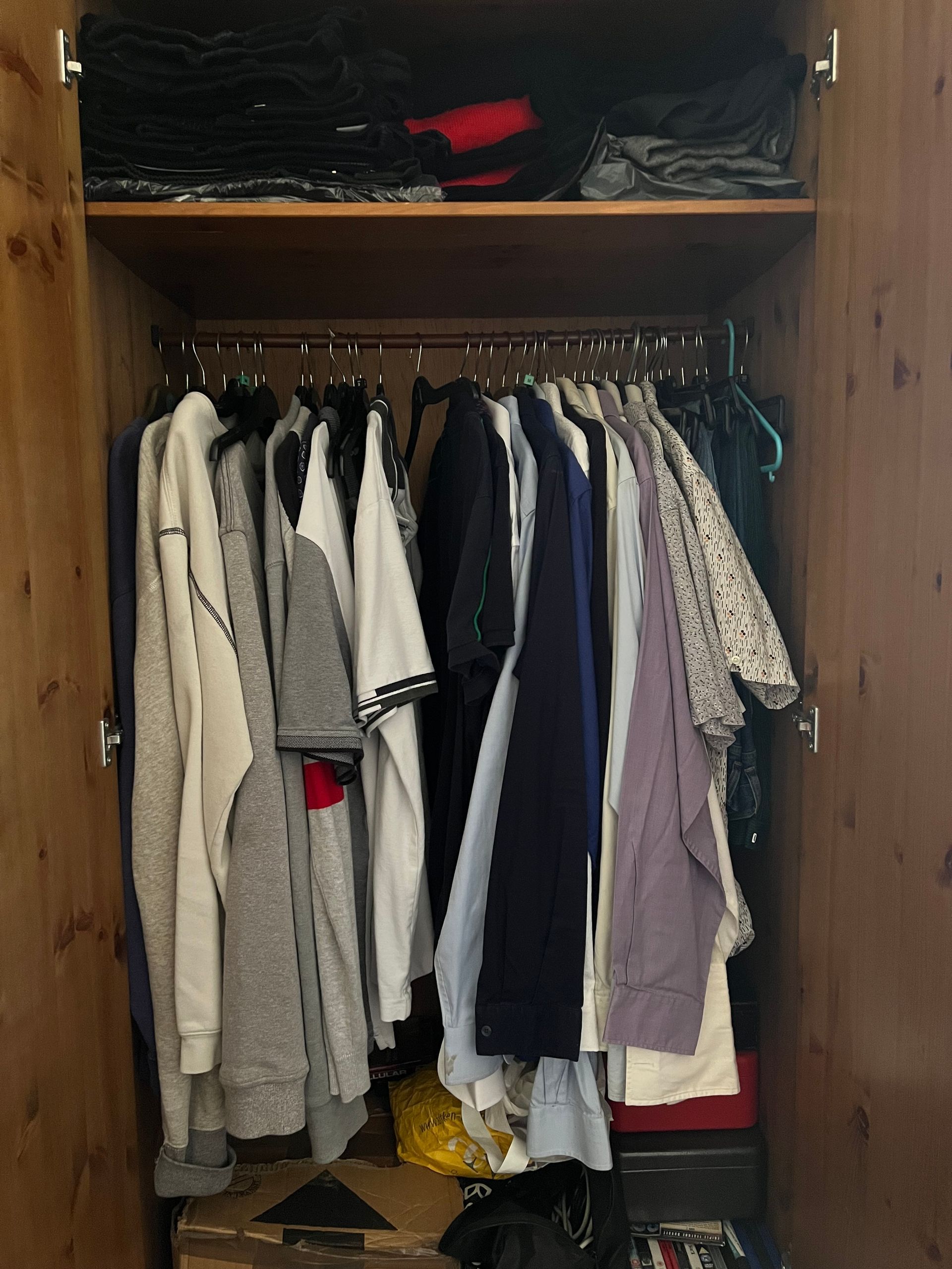 An open wardrobe displaying casual clothing.
