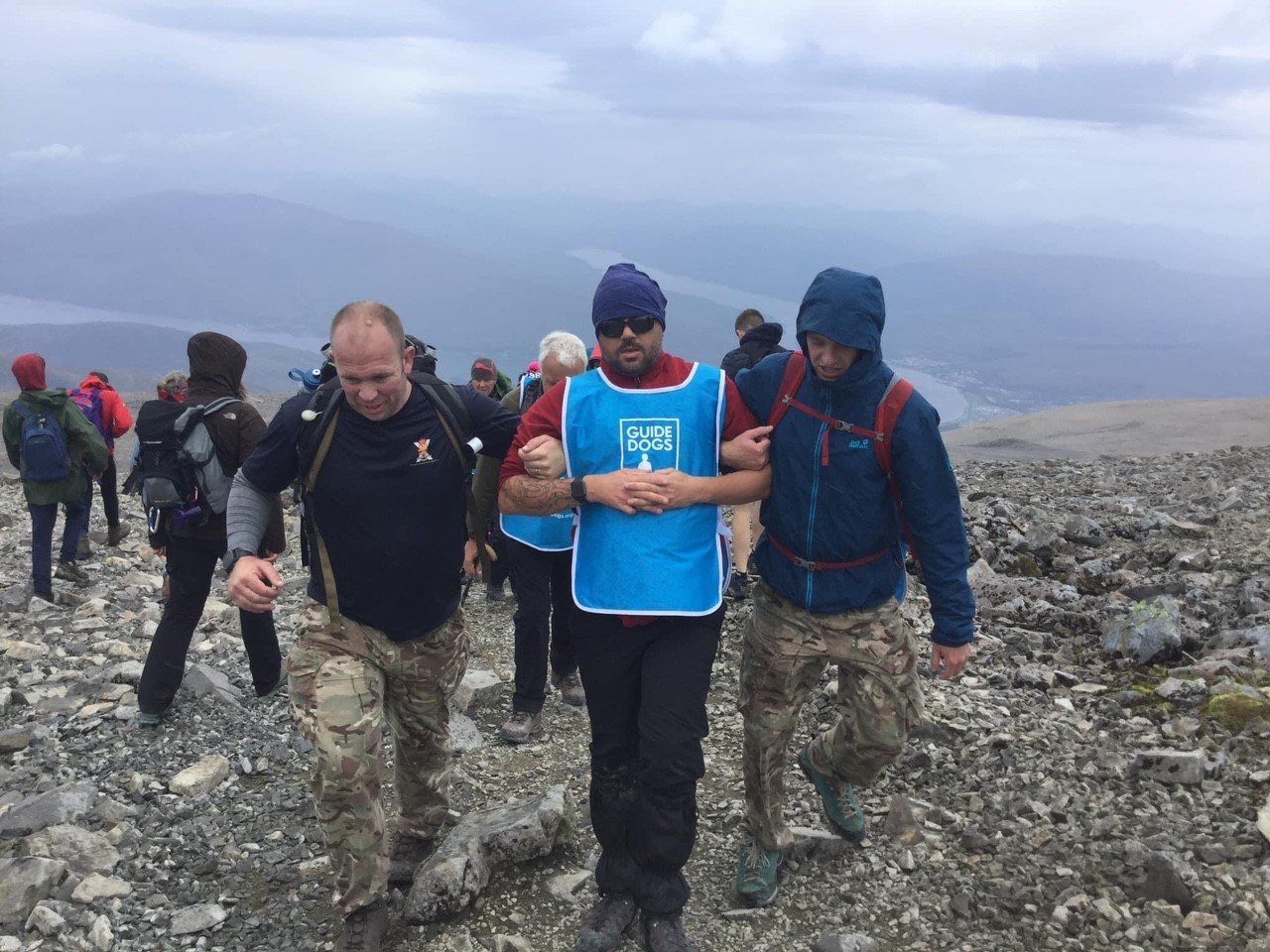 Wayne pugh being guided by Christopher and Ben from the three Scots blackwatch army up Ben Nevis