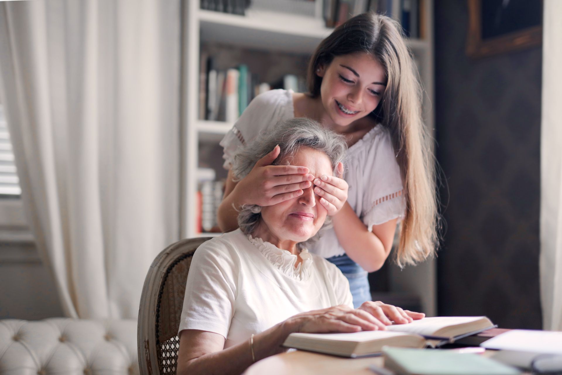 (The Hey, I'm Here Tap Dance) A little girl sneaks up to her grandmother and covers her eyes with a 'guess who'.