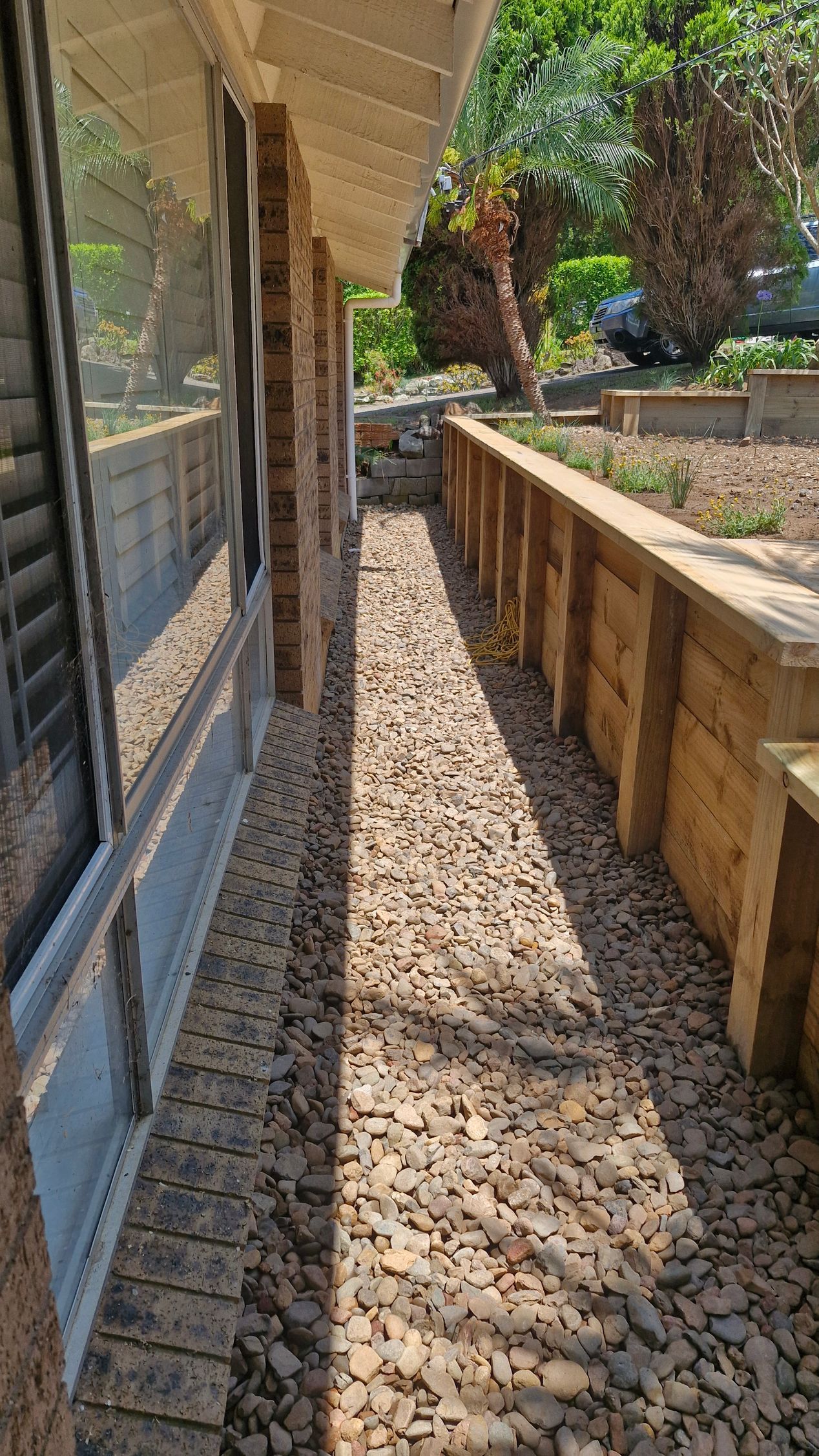 A White Fence Surrounds a Pool With Trees in the Background — Strike Fencing & Gates in Terrigal, NSW