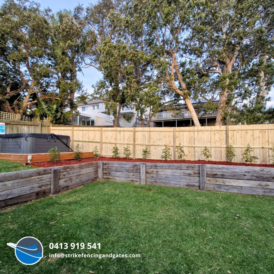 A Man in a Green Shirt is Standing Next to a Pool Behind a Fence — Strike Fencing & Gates in Wamberal, NSW