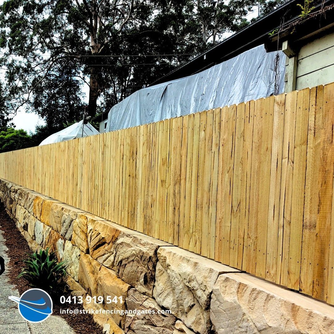 A Pool With a Glass Fence Around It and a House in the Background — Strike Fencing & Gates in Davistown, NSW