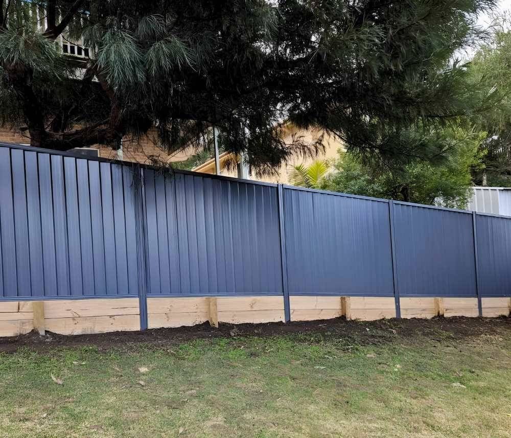 A Blue Fence With a Tree in the Background — Strike Fencing & Gates in Terrigal, NSW