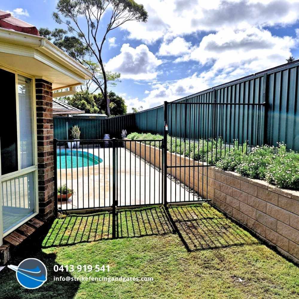 A House With a Fence Around It and a Swimming Pool — Strike Fencing & Gates in Woy Woy, NSW