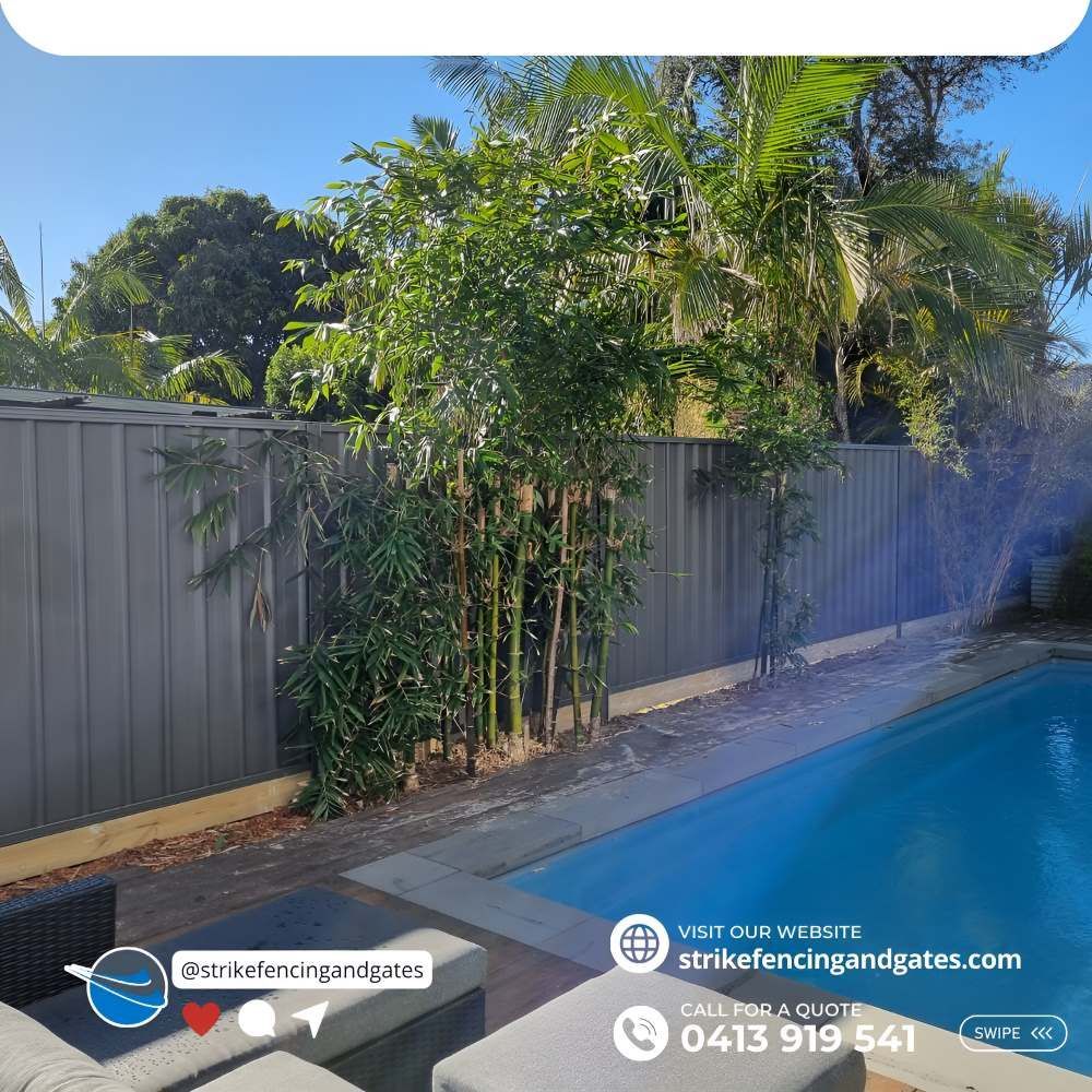 A Fence Surrounds a Swimming Pool in a Backyard — Strike Fencing & Gates in Killarney, NSW