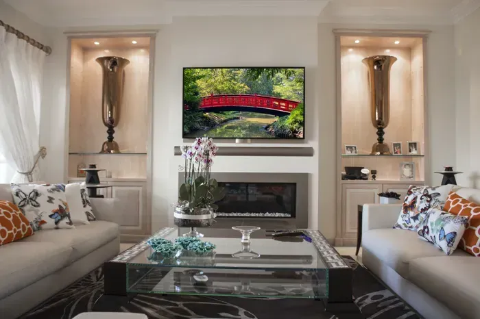 A living room with a fireplace and a flat screen tv