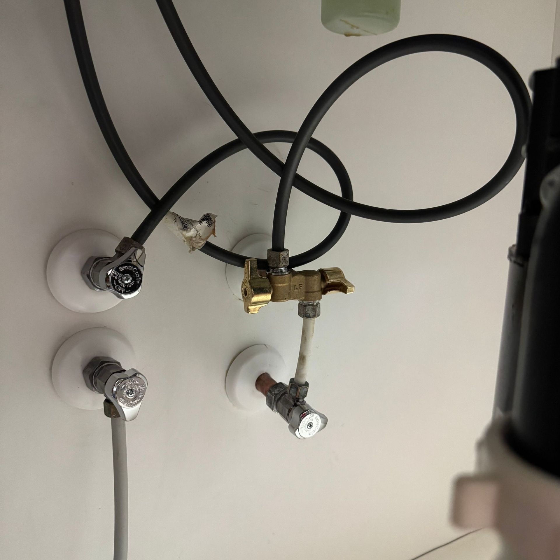 Tarpon Plumbing & Drains - Two black cylinders are sitting next to each other in a room