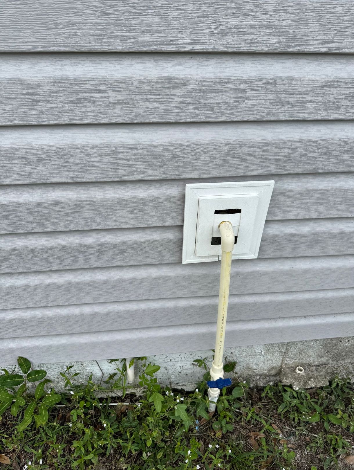 A hose is attached to the side of a house.