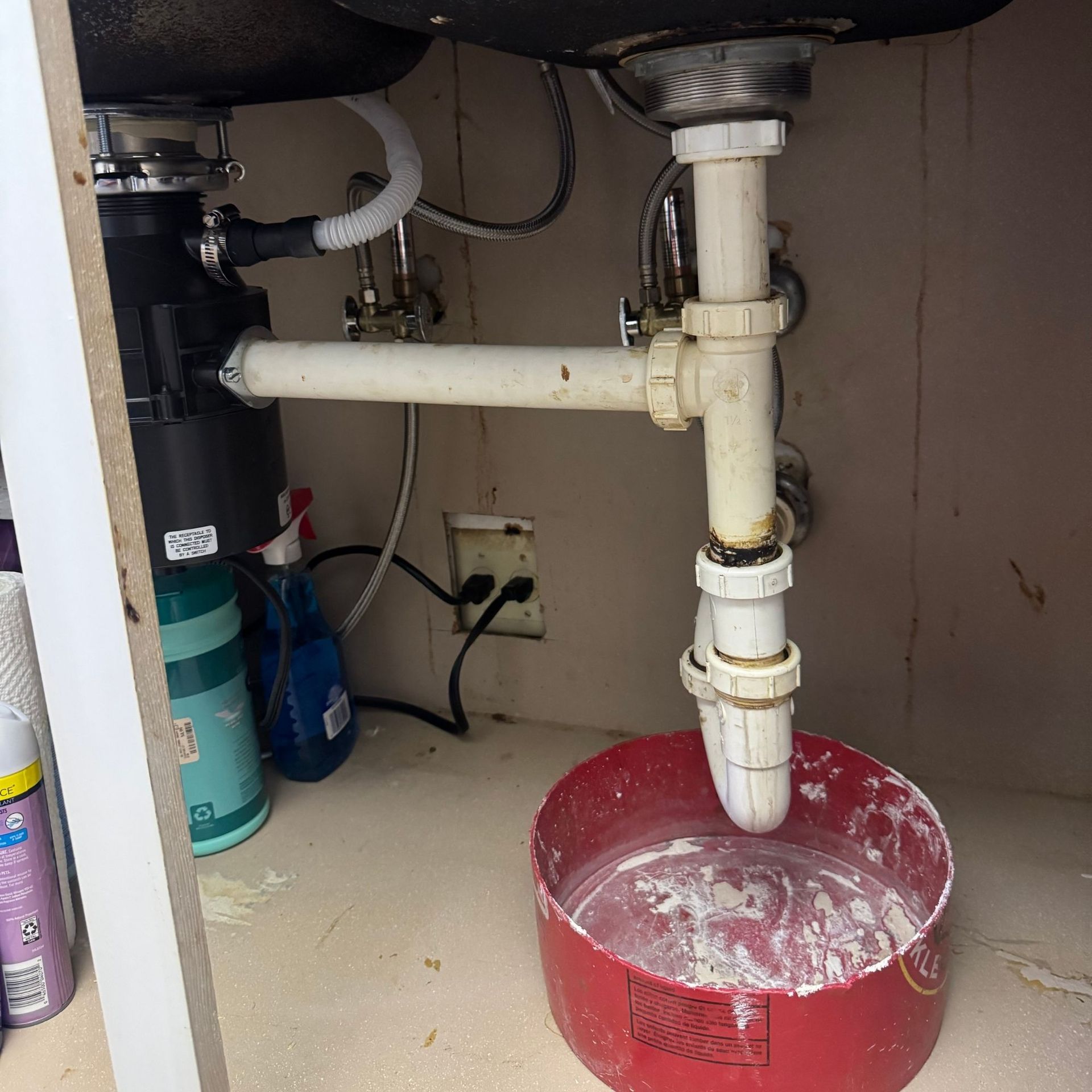 Tarpon Plumbing & Drains -A red bowl filled with water sits under a sink
