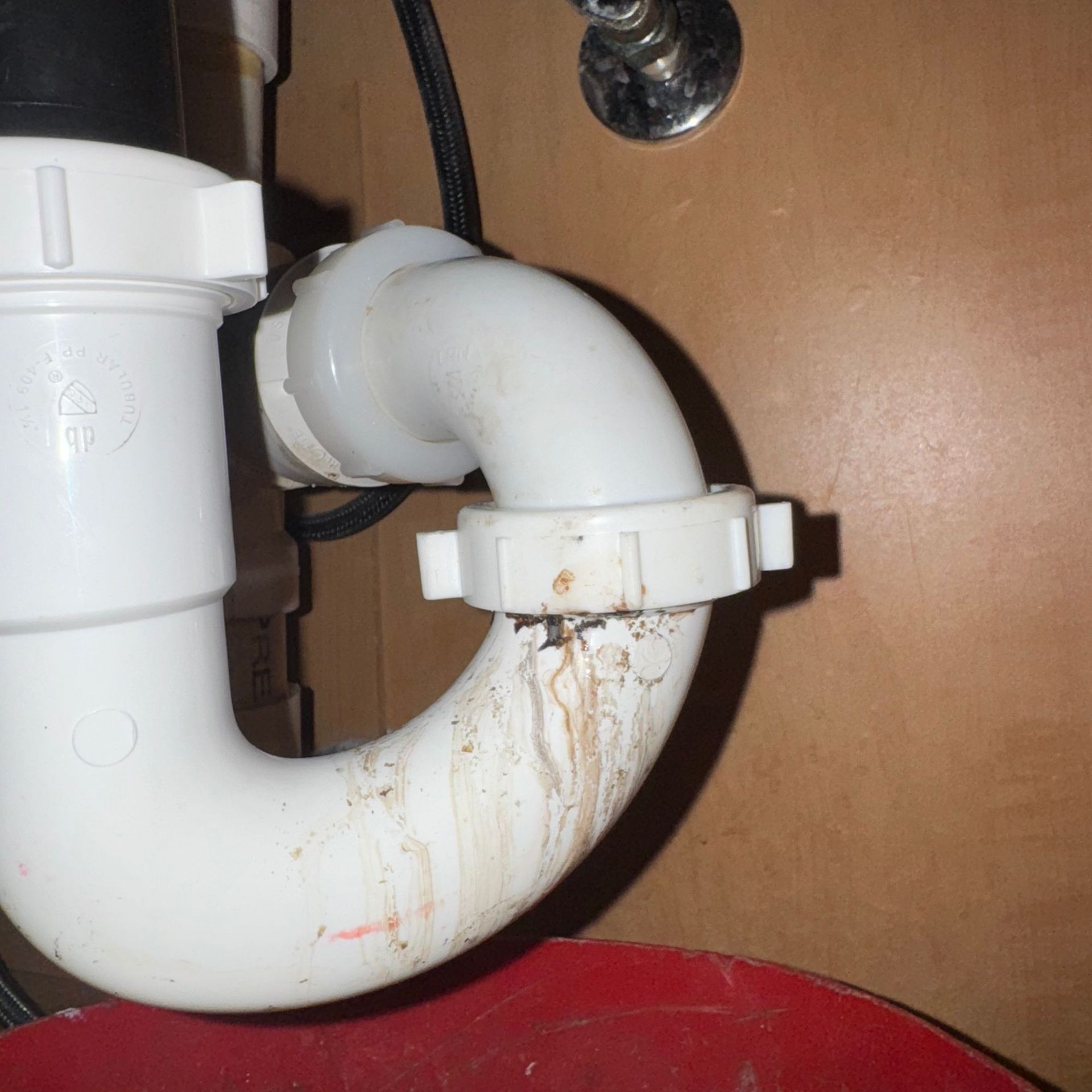 Tarpon Plumbing & Drains - A close up of a white pipe with a black hose attached to it