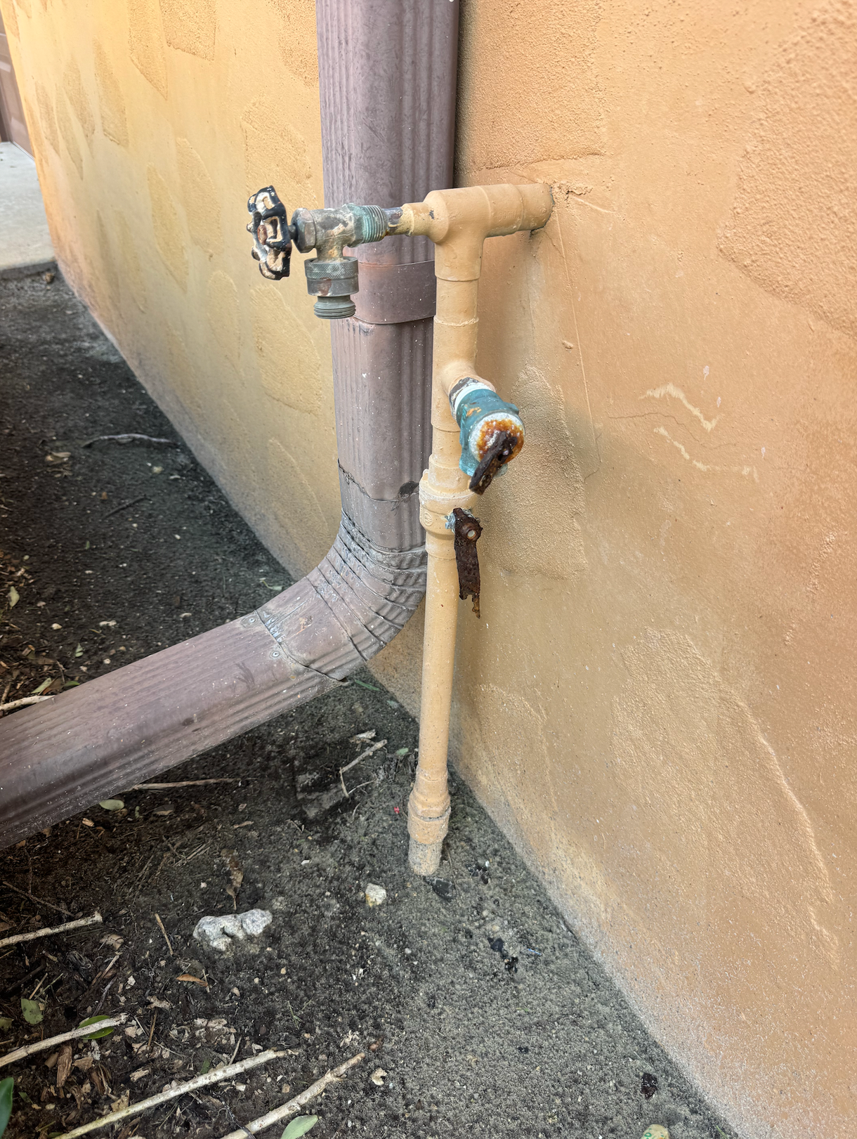 A water pipe is attached to the side of a building.