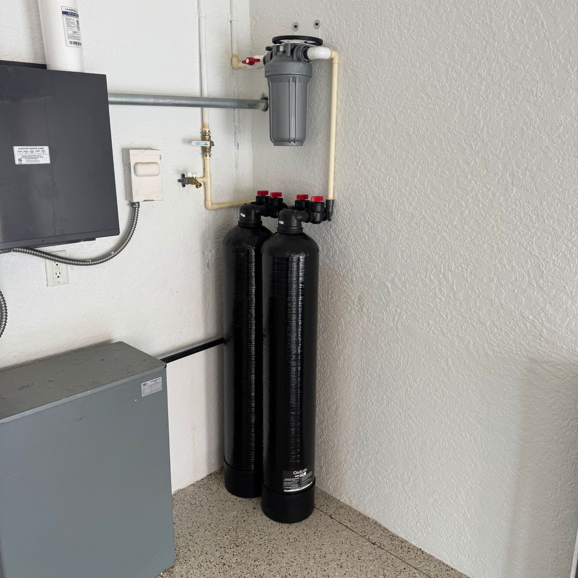 Tarpon Plumbing & Drains - Two black cylinders are sitting next to each other in a room