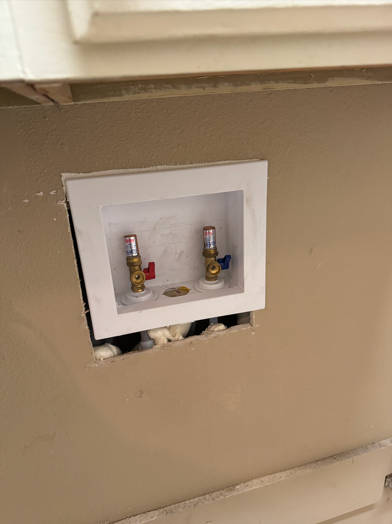 Tarpon Plumbing & Drains - A hole in a wall with two faucets in it.