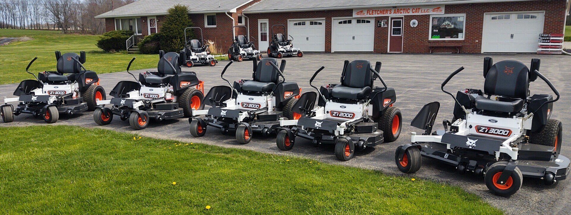 A bobcat zero turn lawn mower is parked in a driveway.
