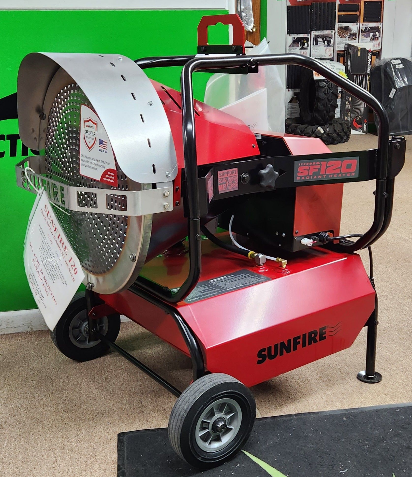 A red sunfire heater is sitting on the floor