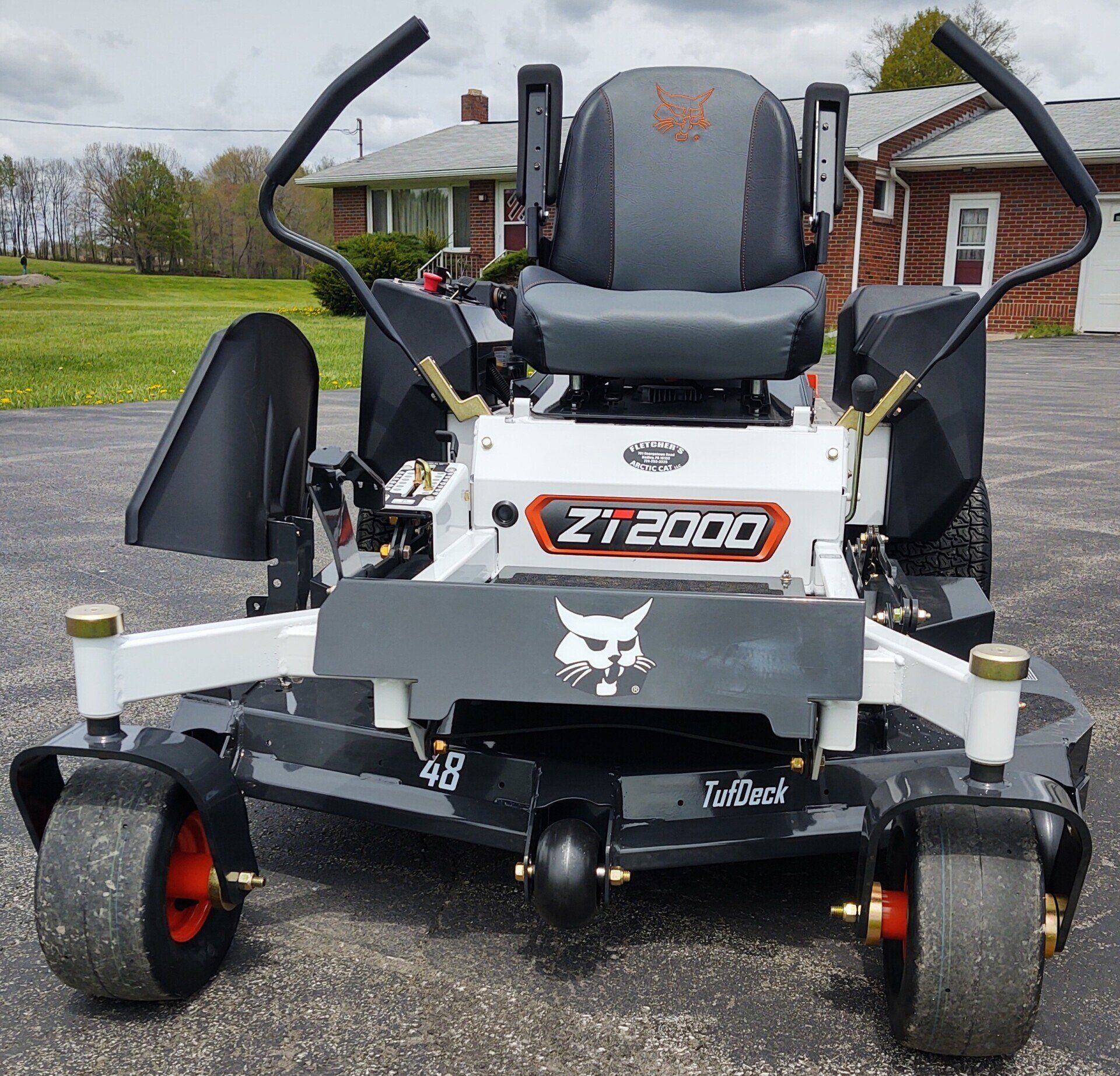 A bobcat zt 2000 lawn mower is parked in a driveway