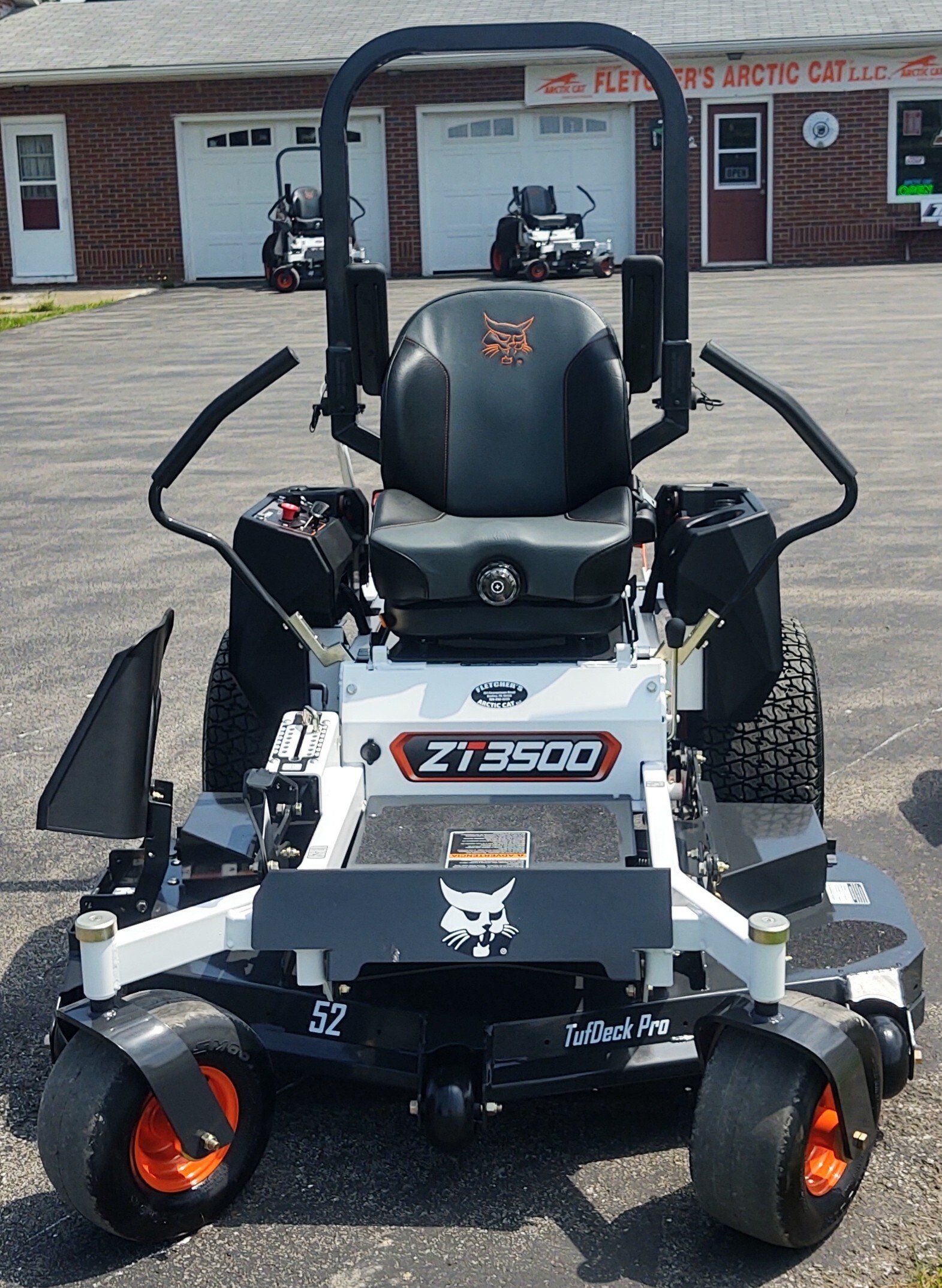 A bobcat lawn mower is parked in a parking lot