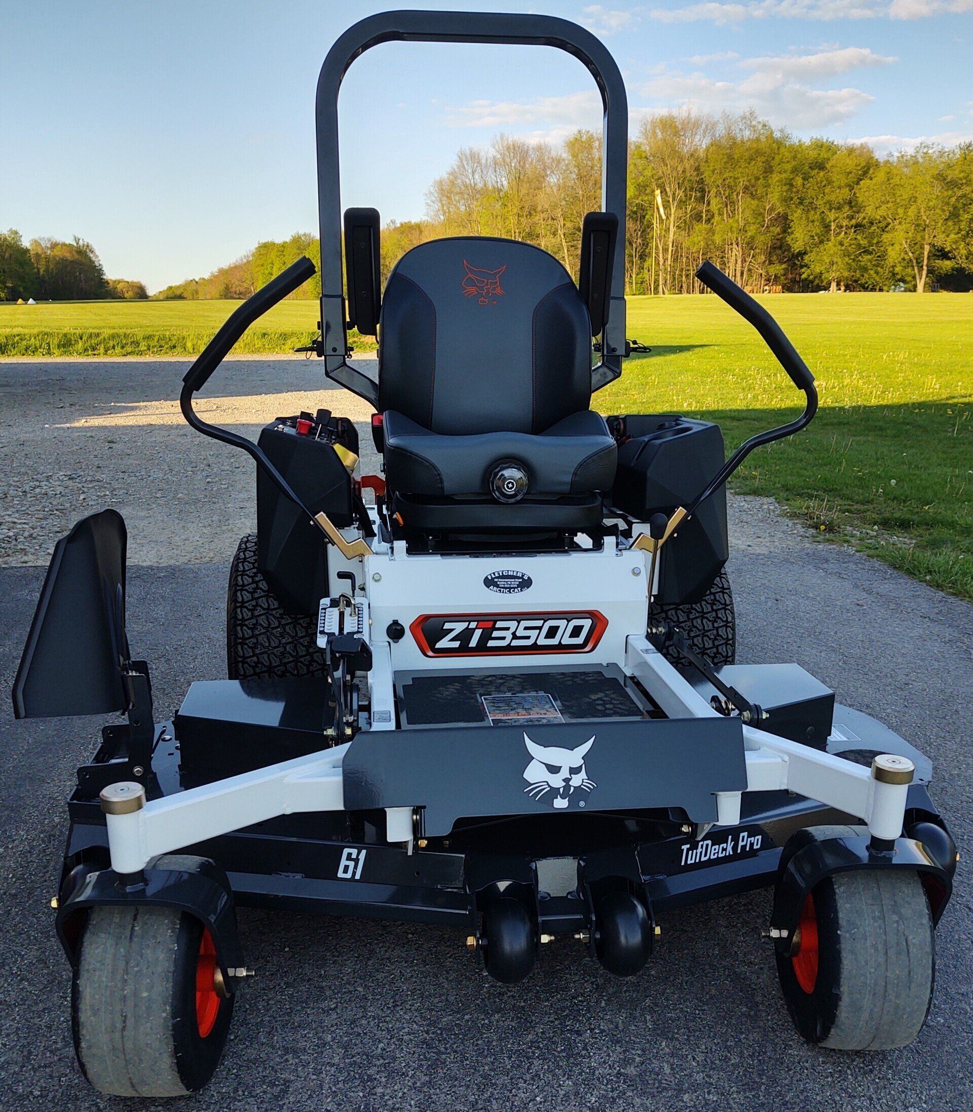 A bobcat zero turn lawn mower is parked on the side of the road.