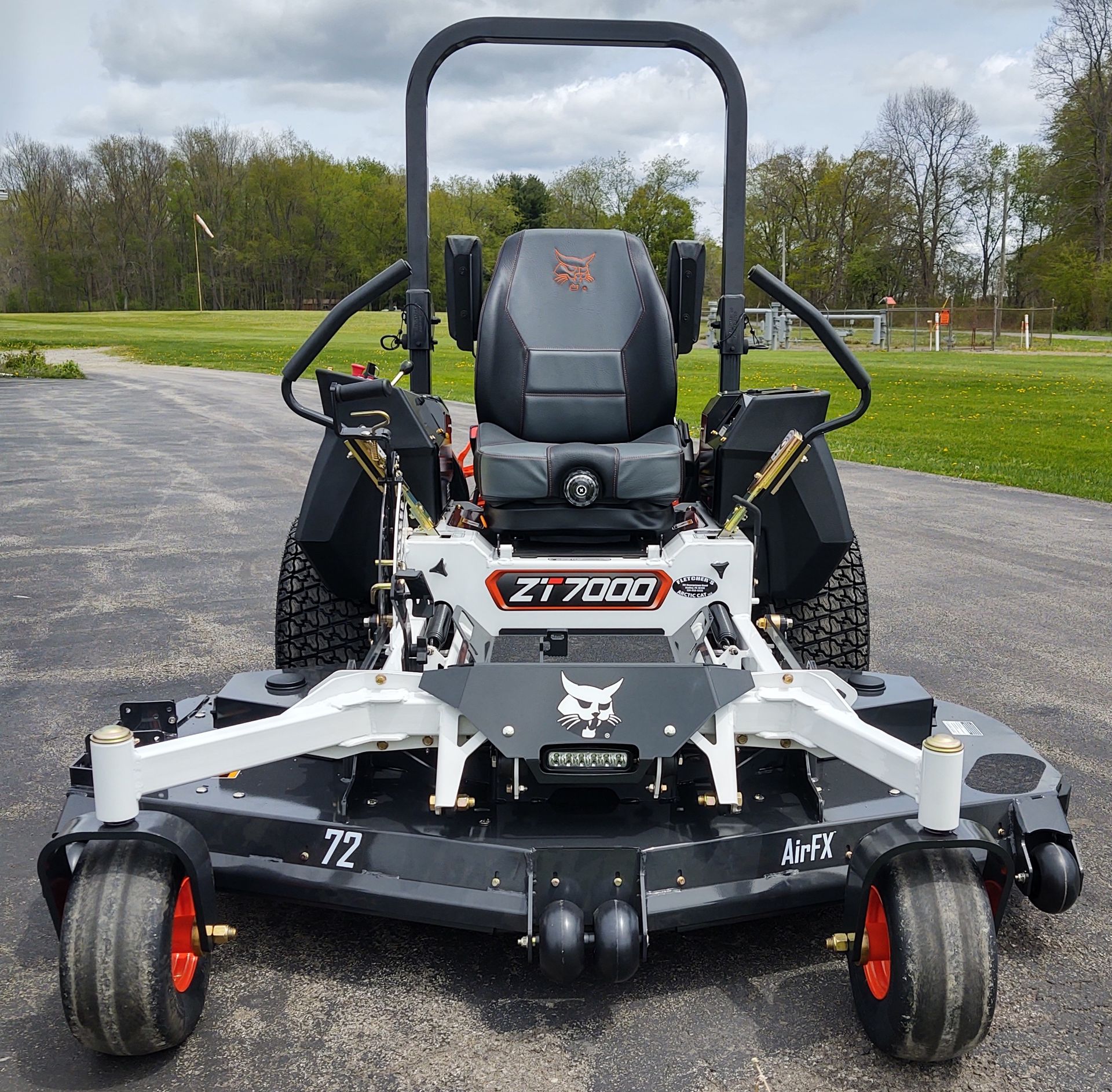 A bobcat lawn mower is parked in a parking lot