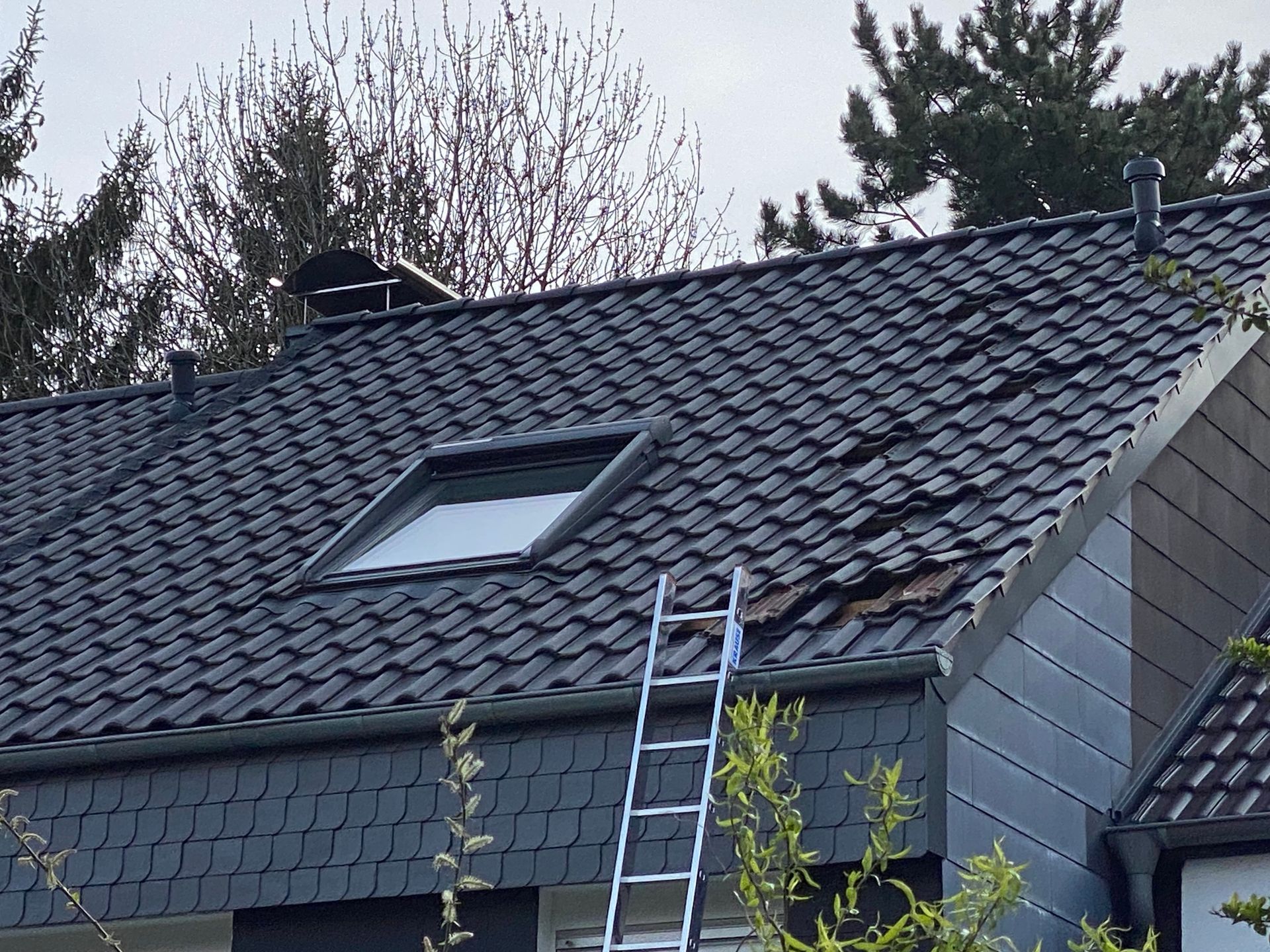 A ladder is sitting on the roof of a house - Holland, PA - Esh Home Improvement LLC