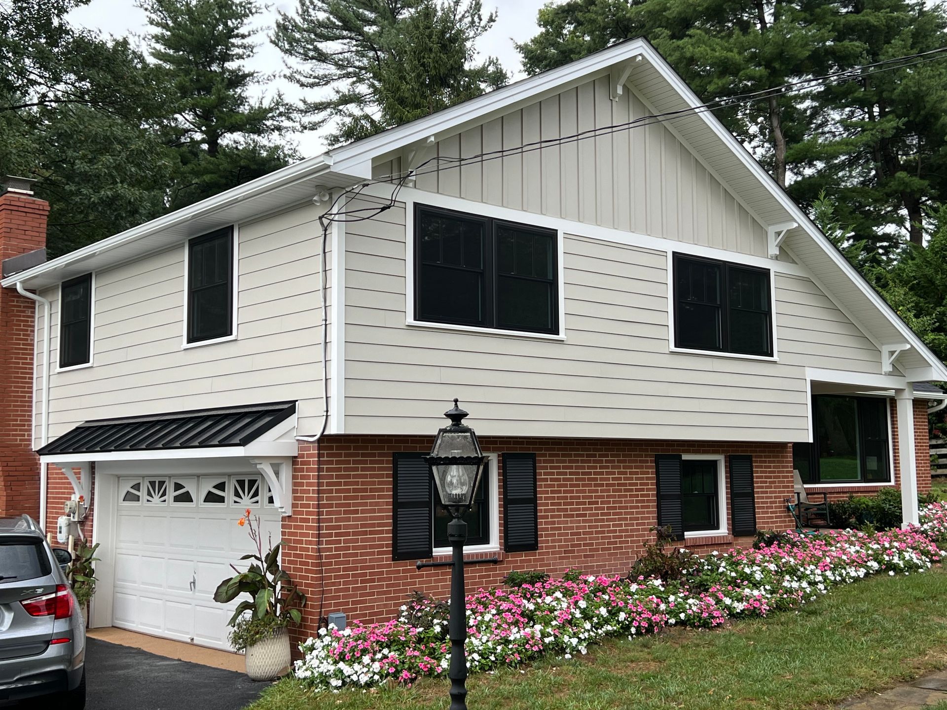 A house with a red roof and flowers in front of it - Holland, PA - Esh Home Improvement LLC