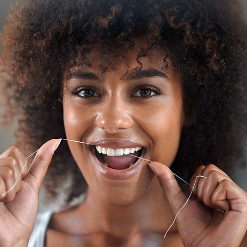 Young Woman Flossing