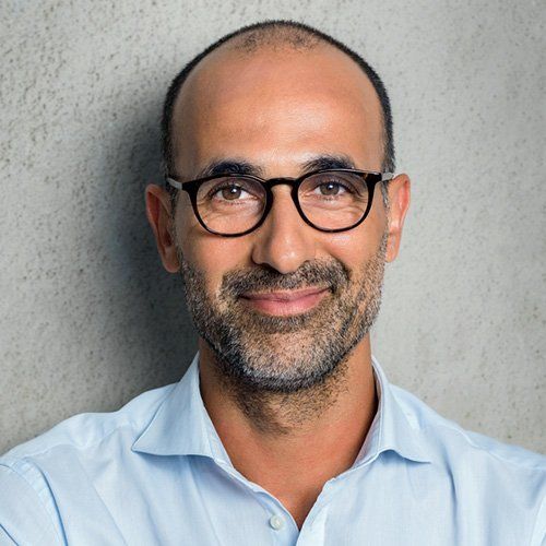 Middle Age man with glasses giving a slight smile