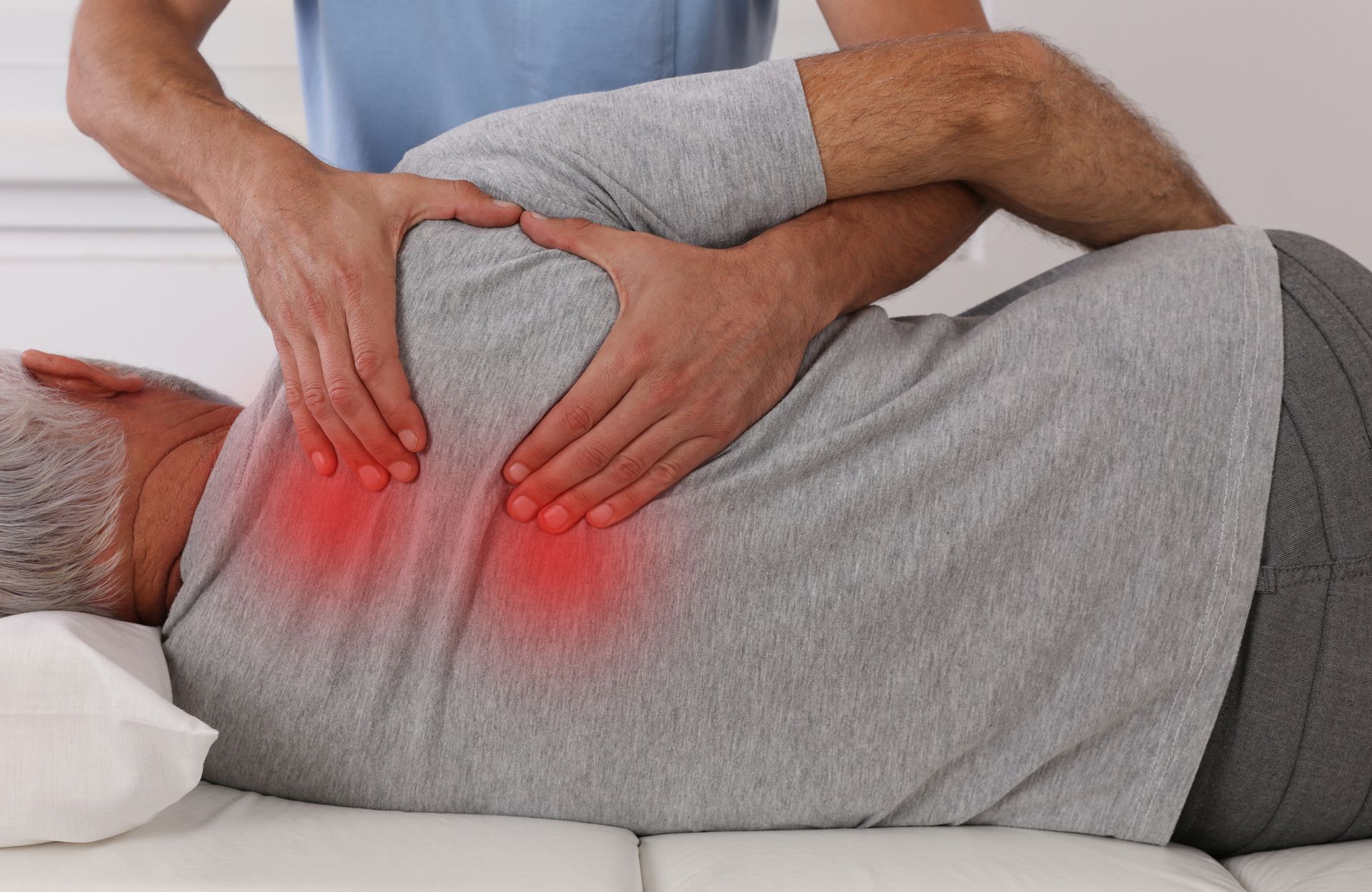 Man receiving chiropractic therapy from professional chiropractor for spinal care.