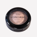 Un recipiente redondo de polvo compacto iluminador vonxane