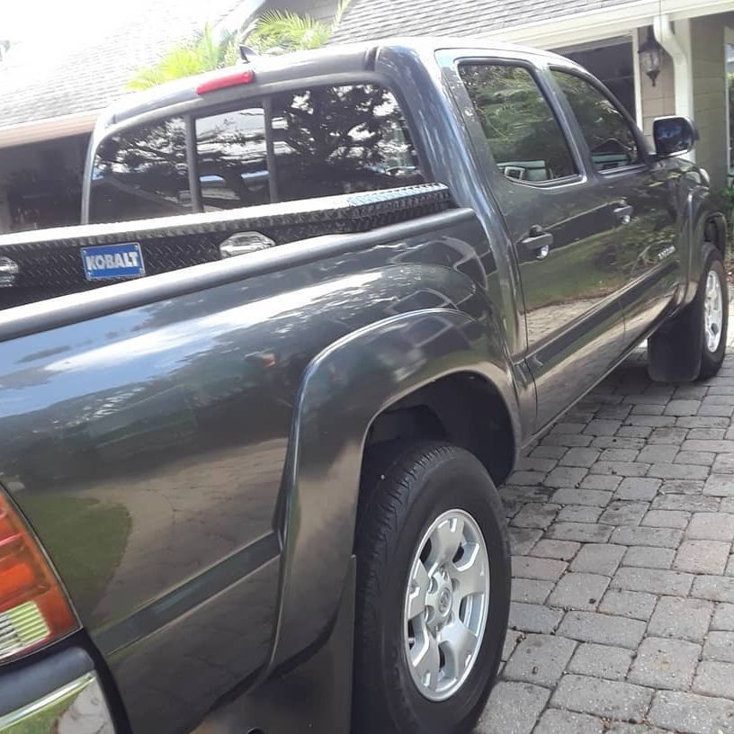 A black truck with a kobalt box in the bed