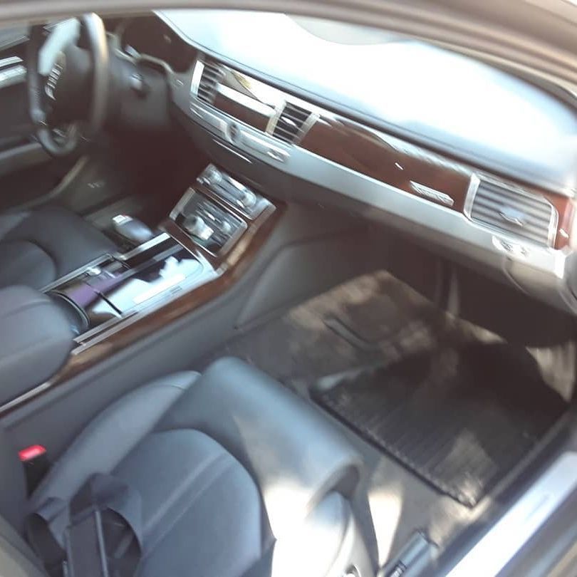 The interior of a car with black seats and a dashboard