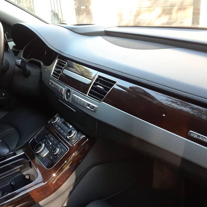 The interior of a car with a wooden dashboard