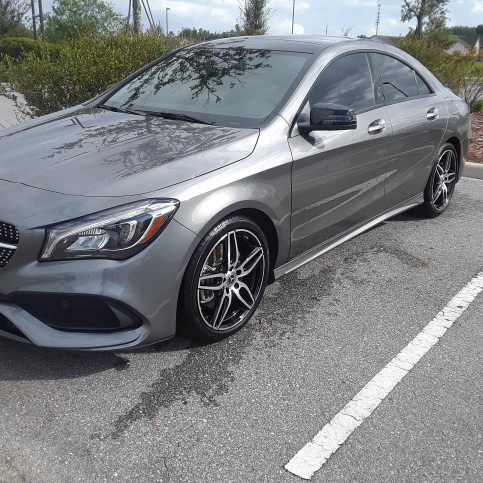 A mercedes benz cla class is parked in a parking lot.